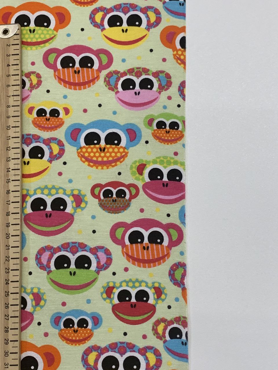 Ottoman Stoffe buntes Affengesicht mit grünem Hintergrund